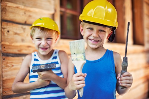 Two children pretending to be builders